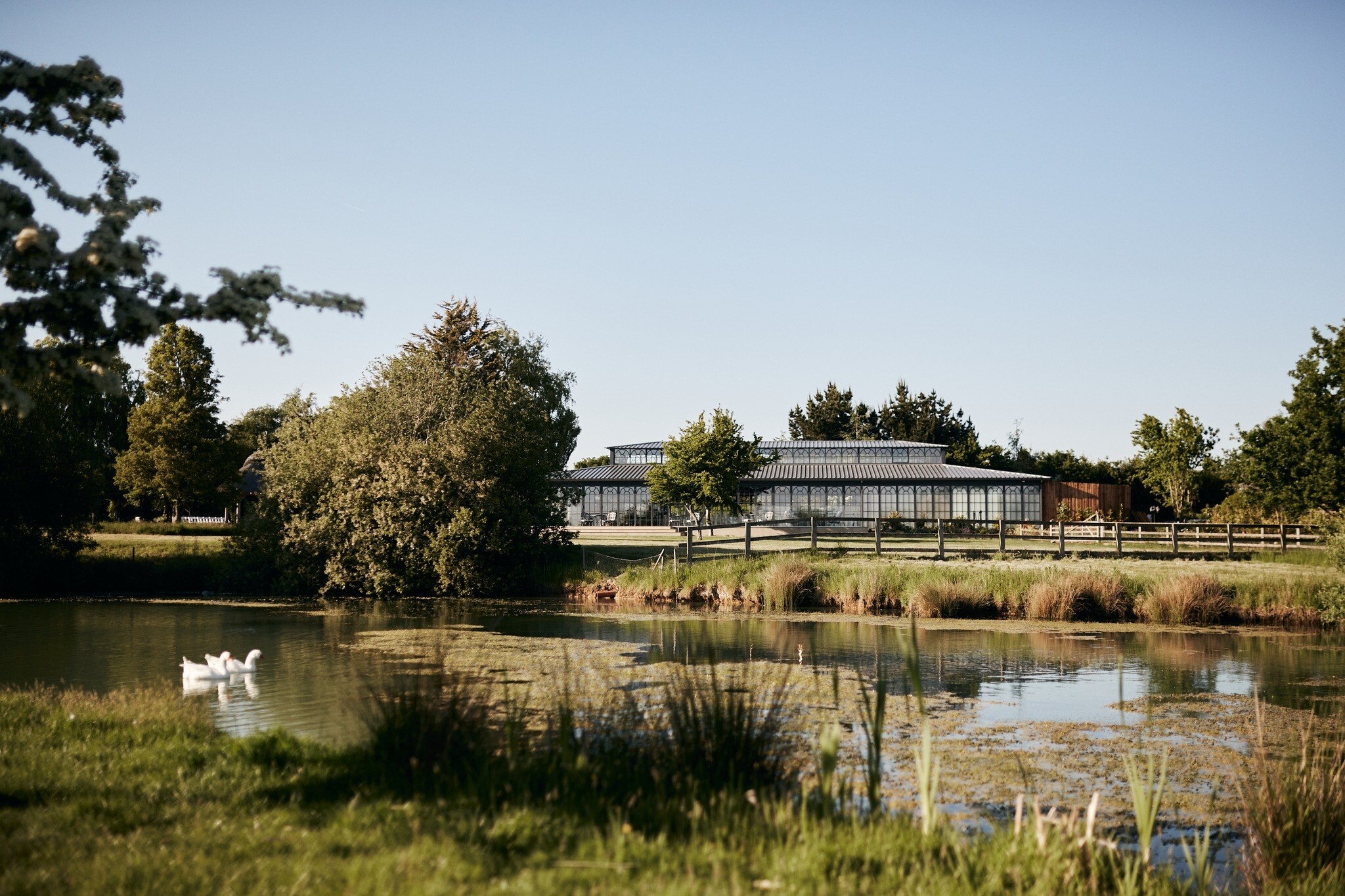 Exterior view of High Houses orangery from their heart-shaped lake