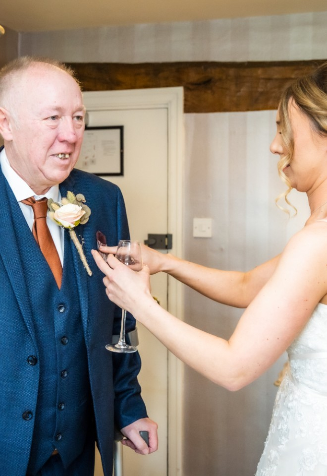 bride helping her father with suit 