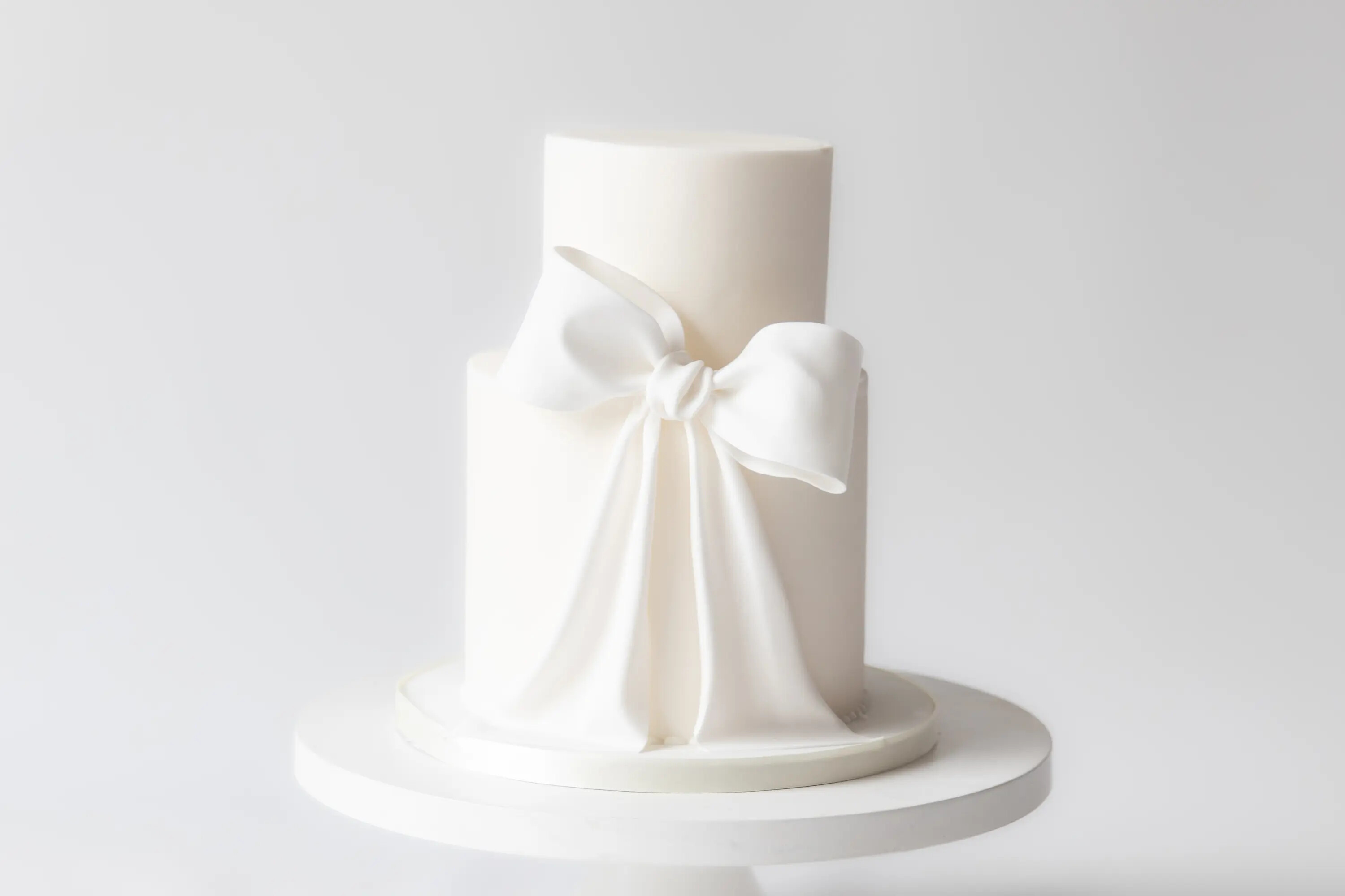 2-tier wedding cake with large fondant bow - available to purchase online from Hall of Cakes