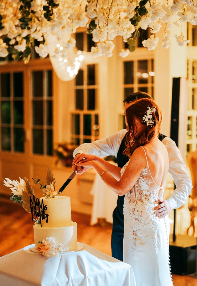 Bride and Groom cutting their wedding cake 