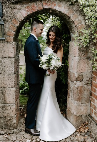 Glewstone Court Real Wedding Bride and Groom photo outside under stone arch