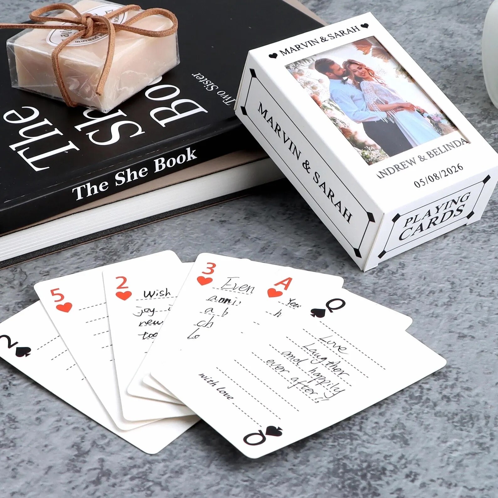 Playing card guest book alternative with personalised deck and box, where guests write messages on individual cards, creating a keepsake that can be stored and reused.