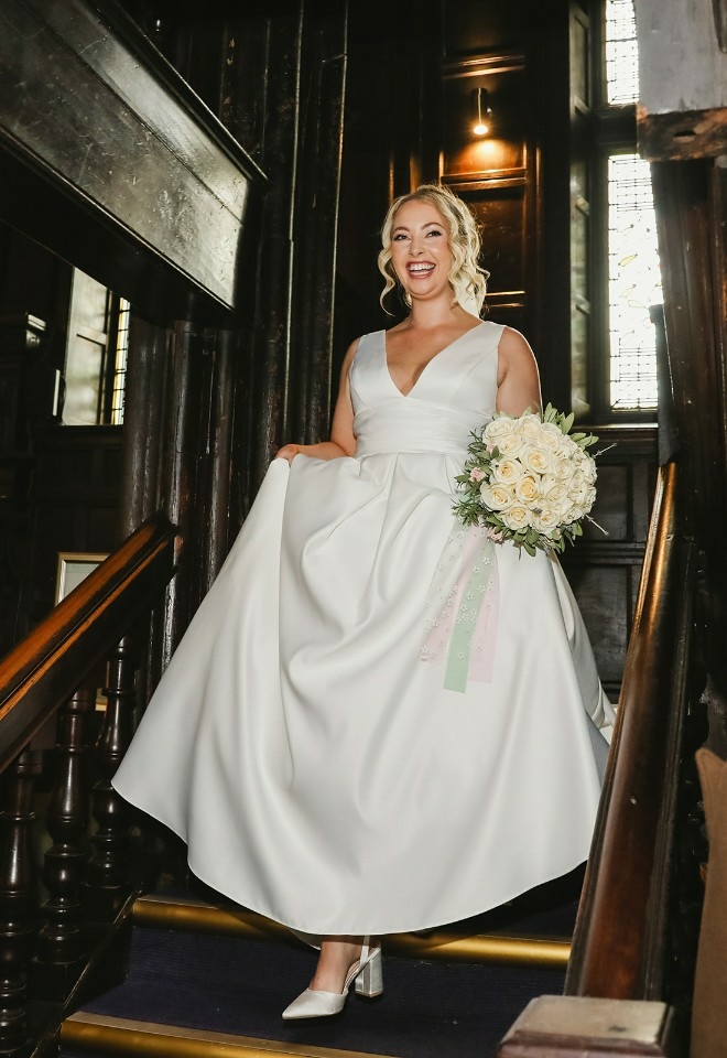 Bride walking down the stairs at Mitton Hall