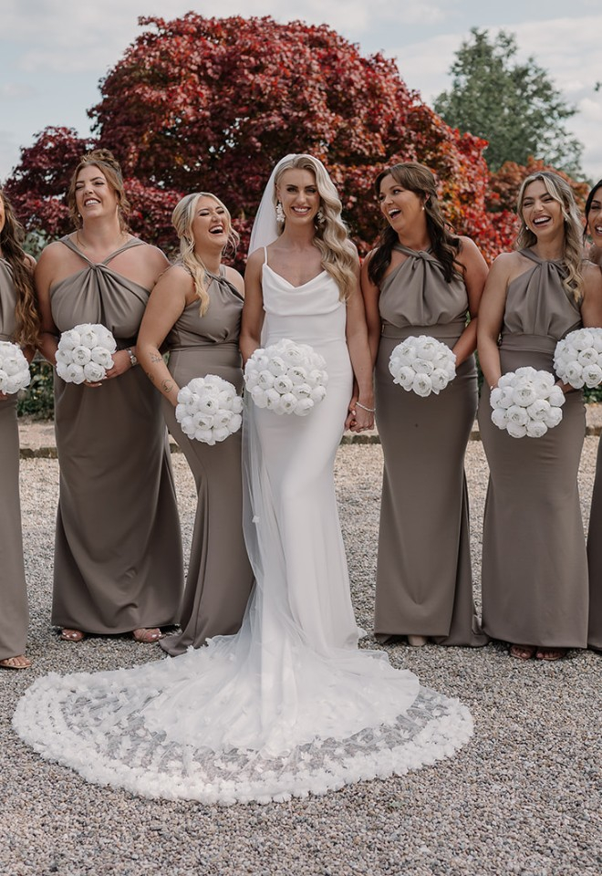 Bridesmaids in taupe dresses with bride