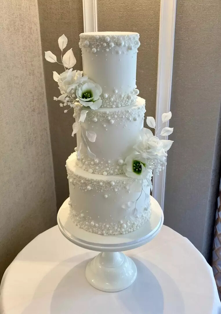 3 tier wedding cake designed by Cakes of Curiosity, with white pearls and peonies