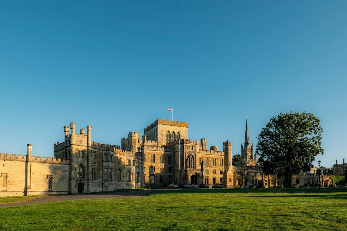 Exterior of Ashridge House in Hertfordshire, showing the historic estate and surrounding grounds in summer evening light