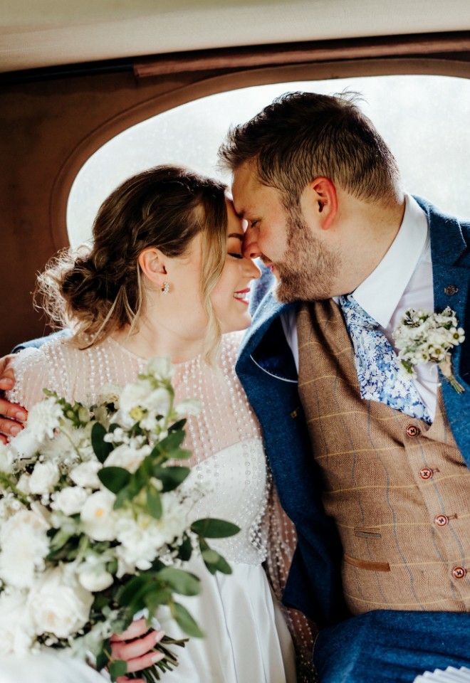 bride and groom in the wedding car