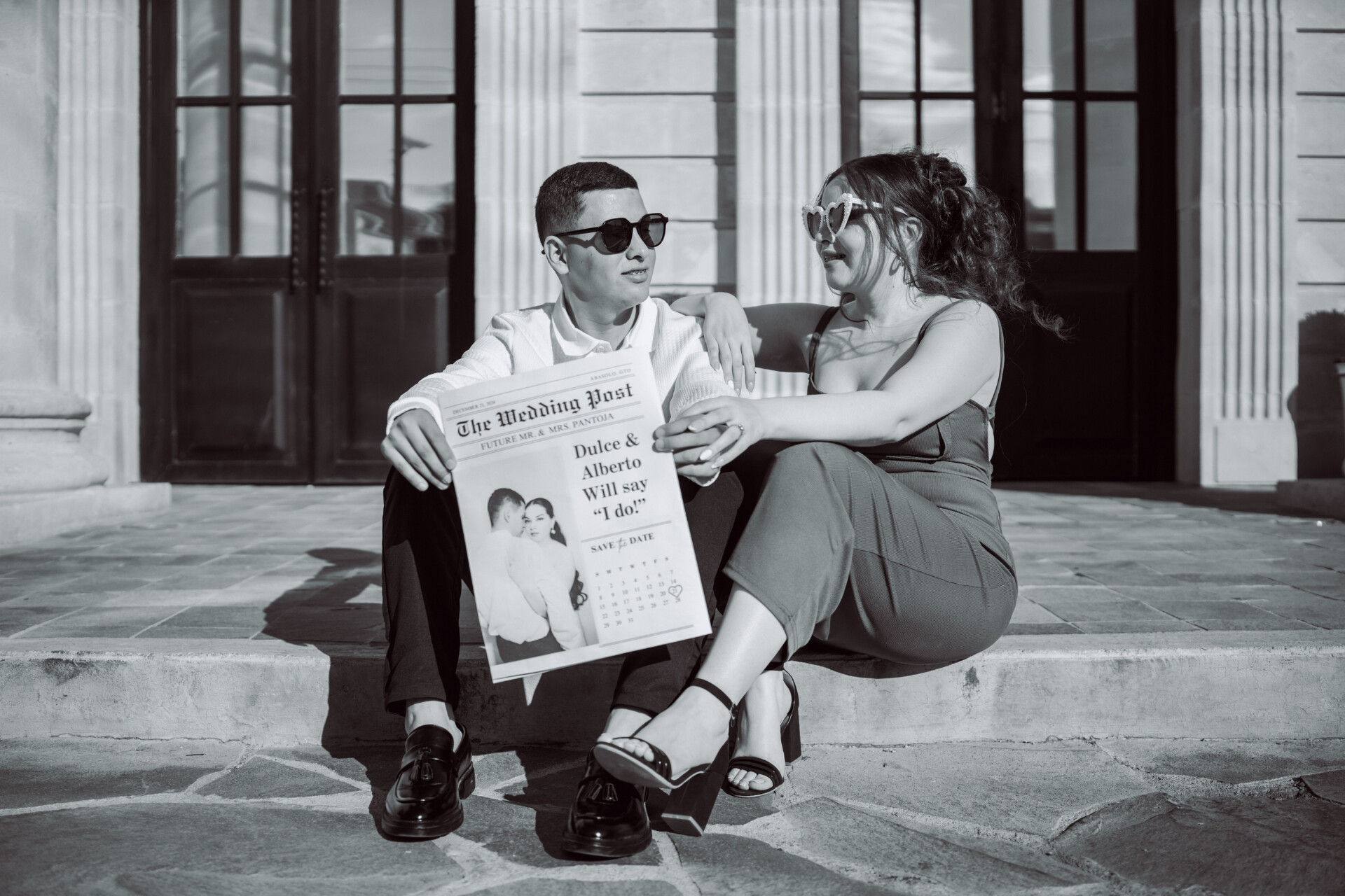 couple reading a "save the date" wedding newspaper