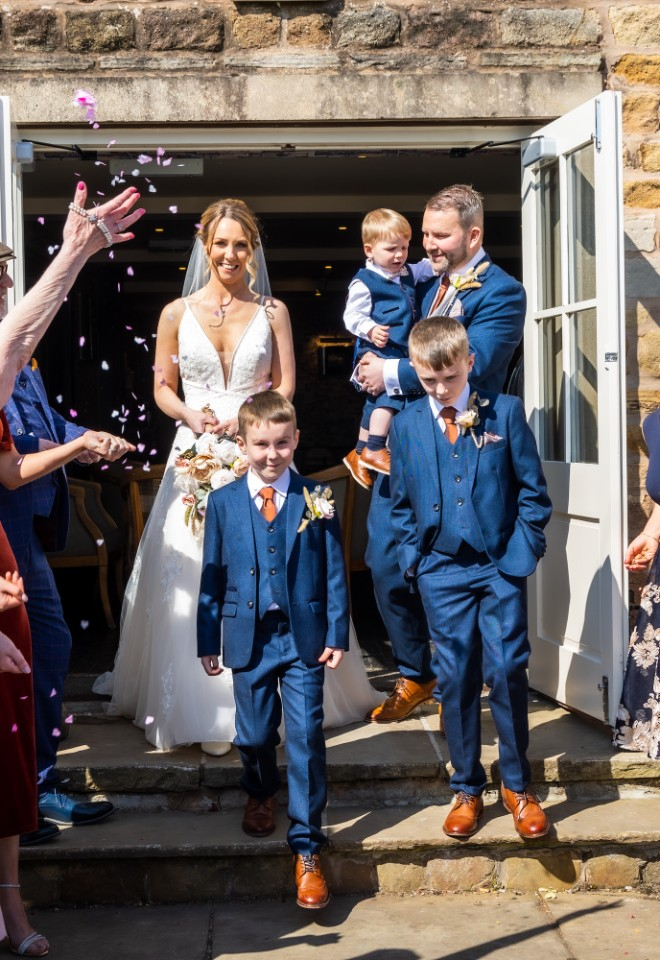family confetti shot walking out of the ceremony