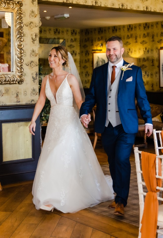 bride and groom walking into their wedding breakfast