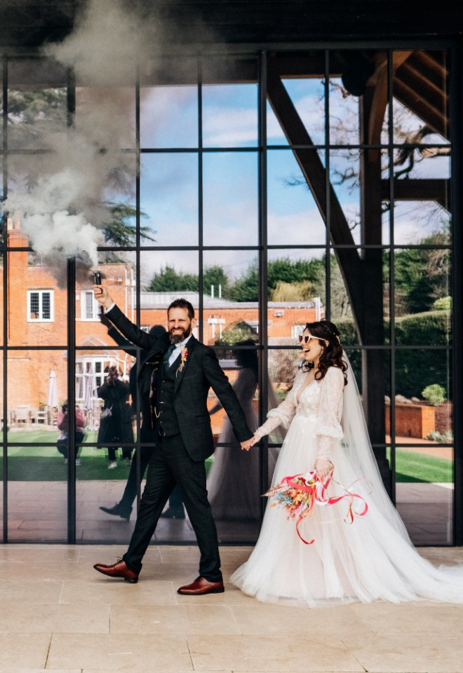 Bride and groom walking next to the Post Barn