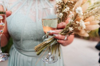 Bridesmaid close up photo with champagne, flowers and flower nails