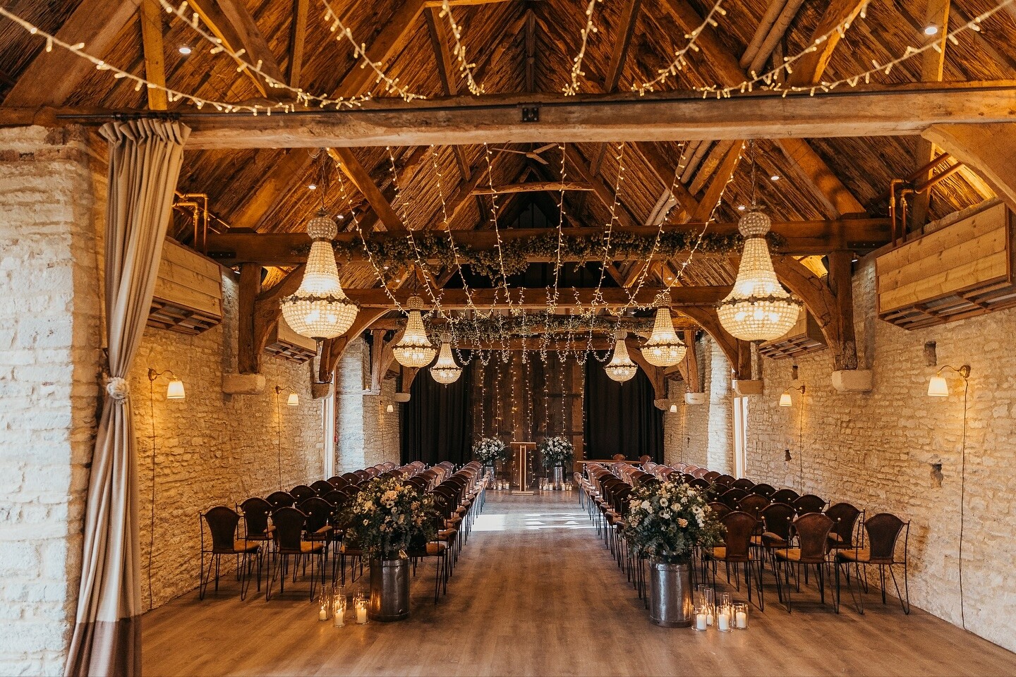 Inside the Tythe Barn and Farmhouse, Oxfordshire, set for a wedding ceremony