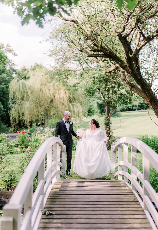 Bride and groom on the bridge at Clevedon Hall