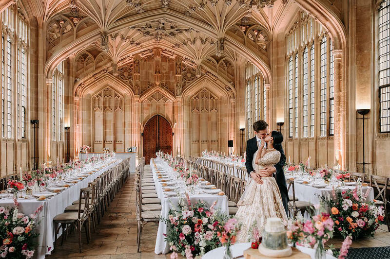 Bride and groom kiss inside the bodelian library, which has been set for a wedding breakfast