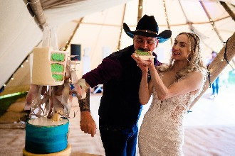 Bride and Groom cutting and eating cake