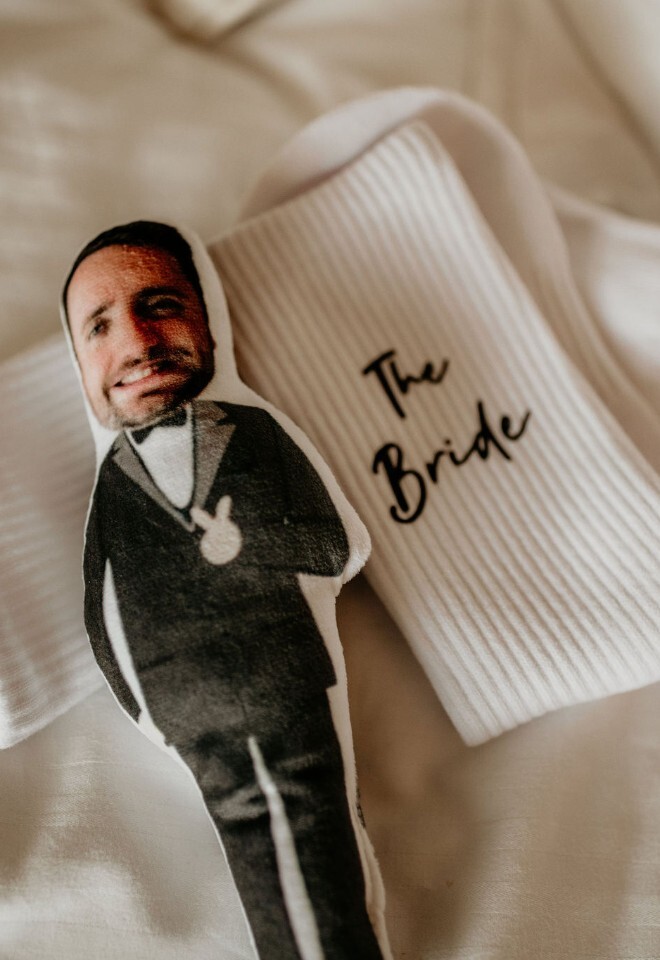 Personalised wedding socks with “The Bride” text and a printed cut-out of the groom on top.