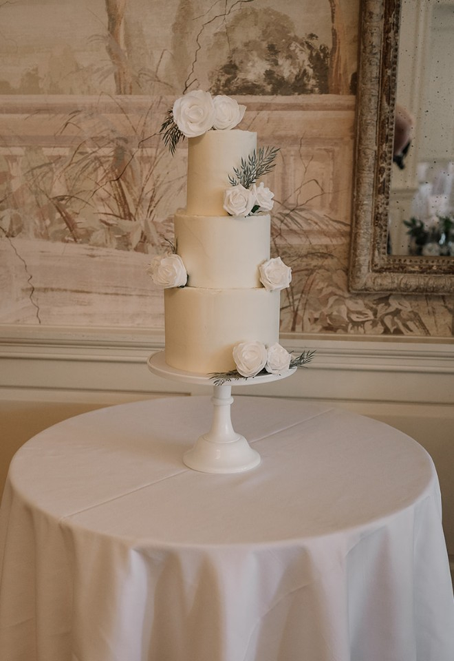 White wedding cake with three tiers and flowers