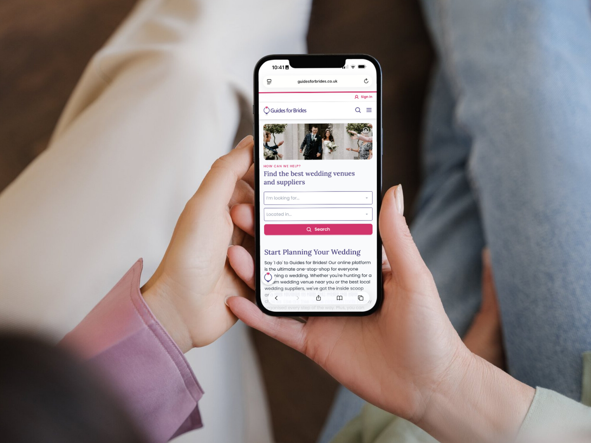Close up of hands holding a smart phone with Guides for Brides on screen