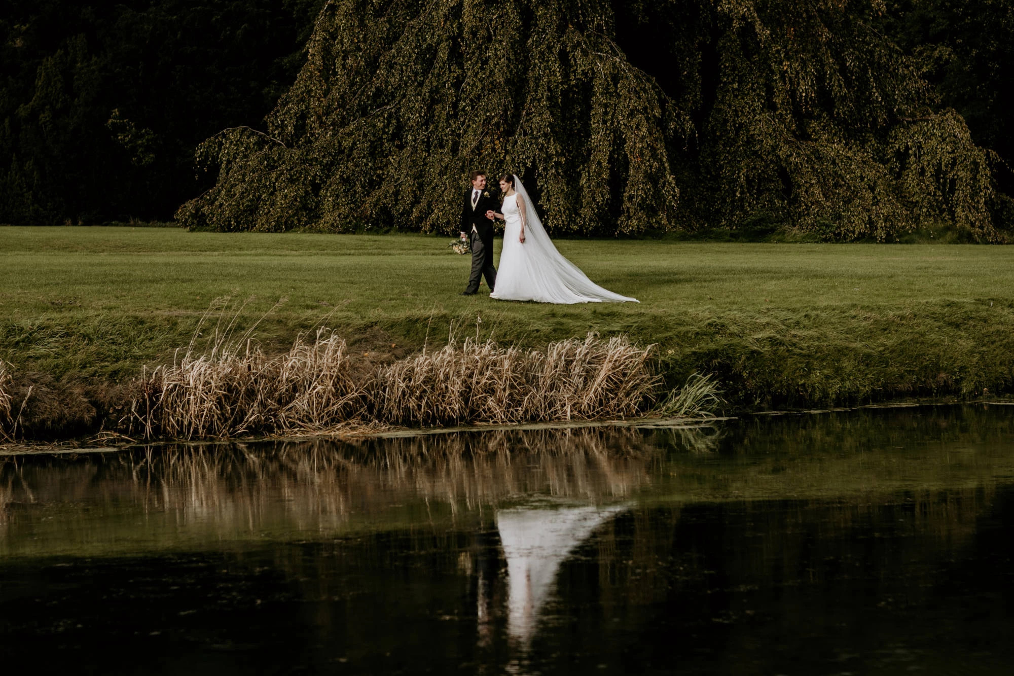 newly weds walking along lake