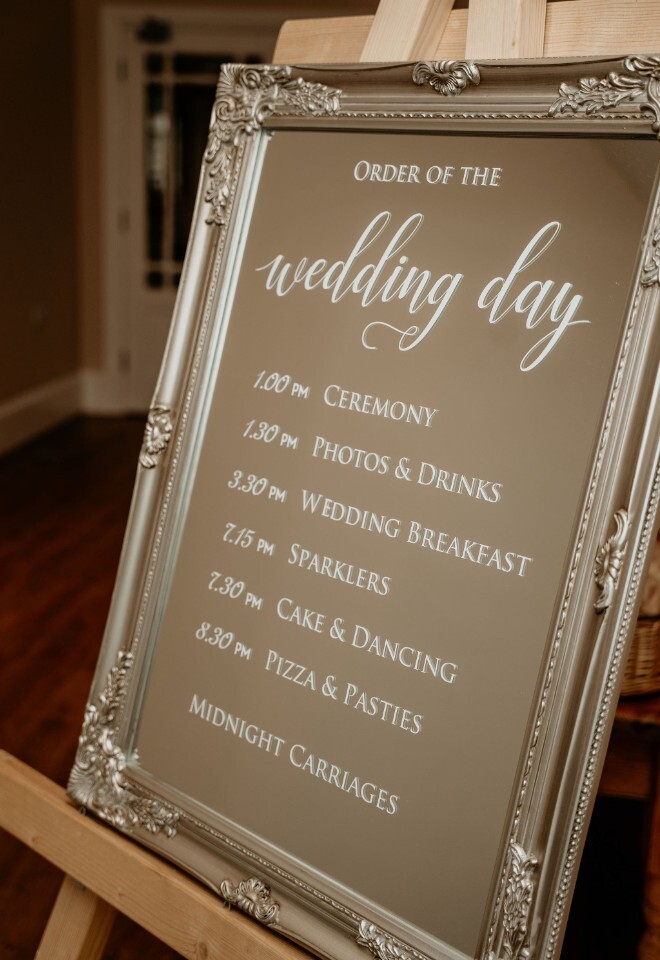 personalised mirror on an easel frame with the order of wedding day printed on 