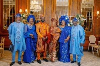 Bride and Groom with families in traditional nigerian clothing 