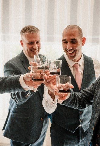 Groom and groomsmen doing a cheers at Southdowns Manor West Sussex