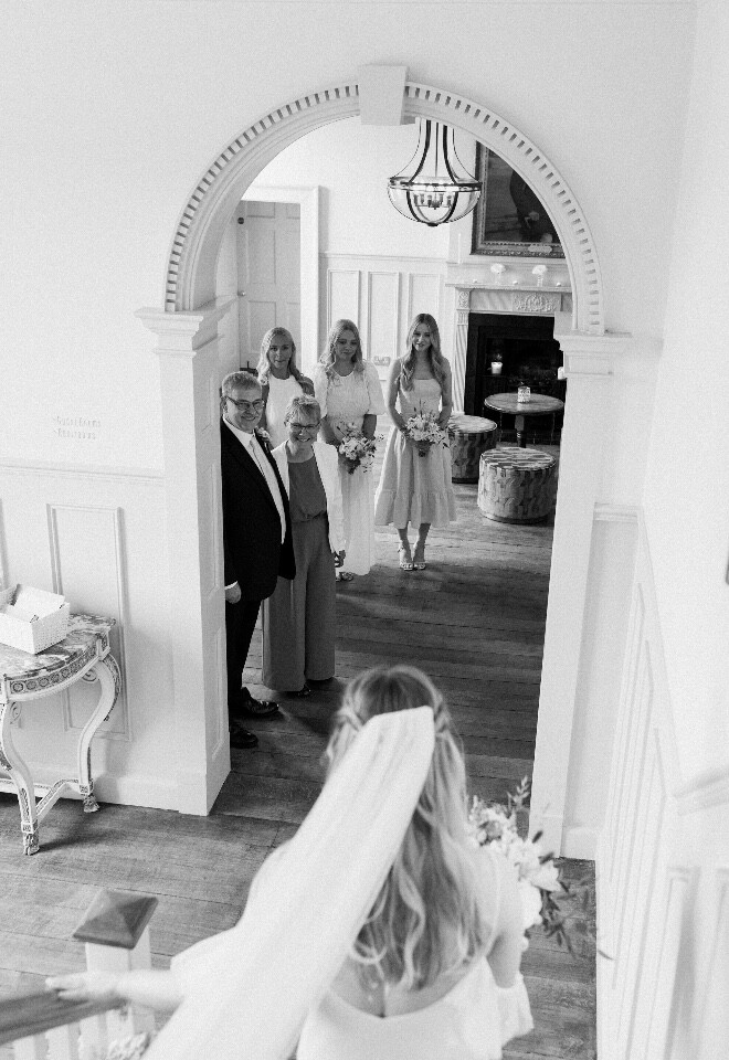 Bride walking down the stairs for her first look