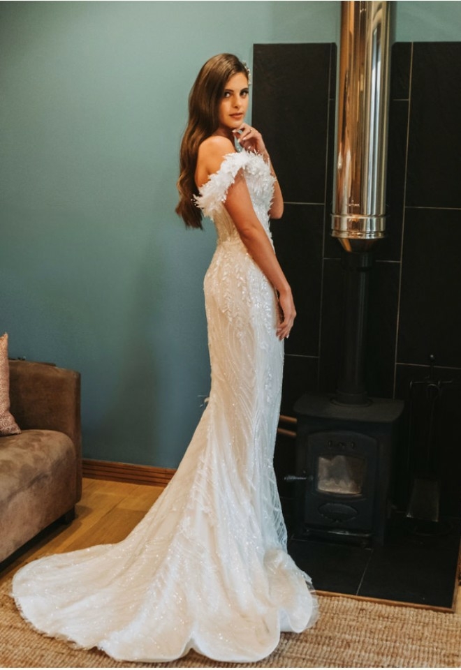 bride posing in the lodge beside the sofa