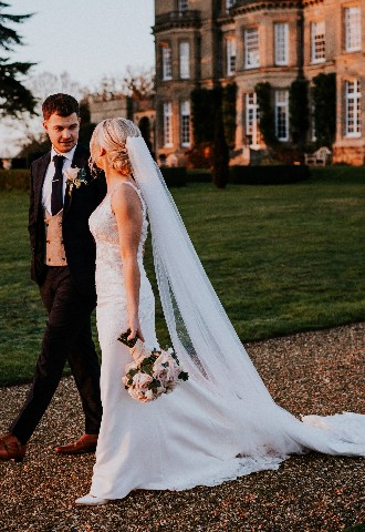 Bride and groom walking in grounds of Hedsor House wedding venue Buckinghamshire
