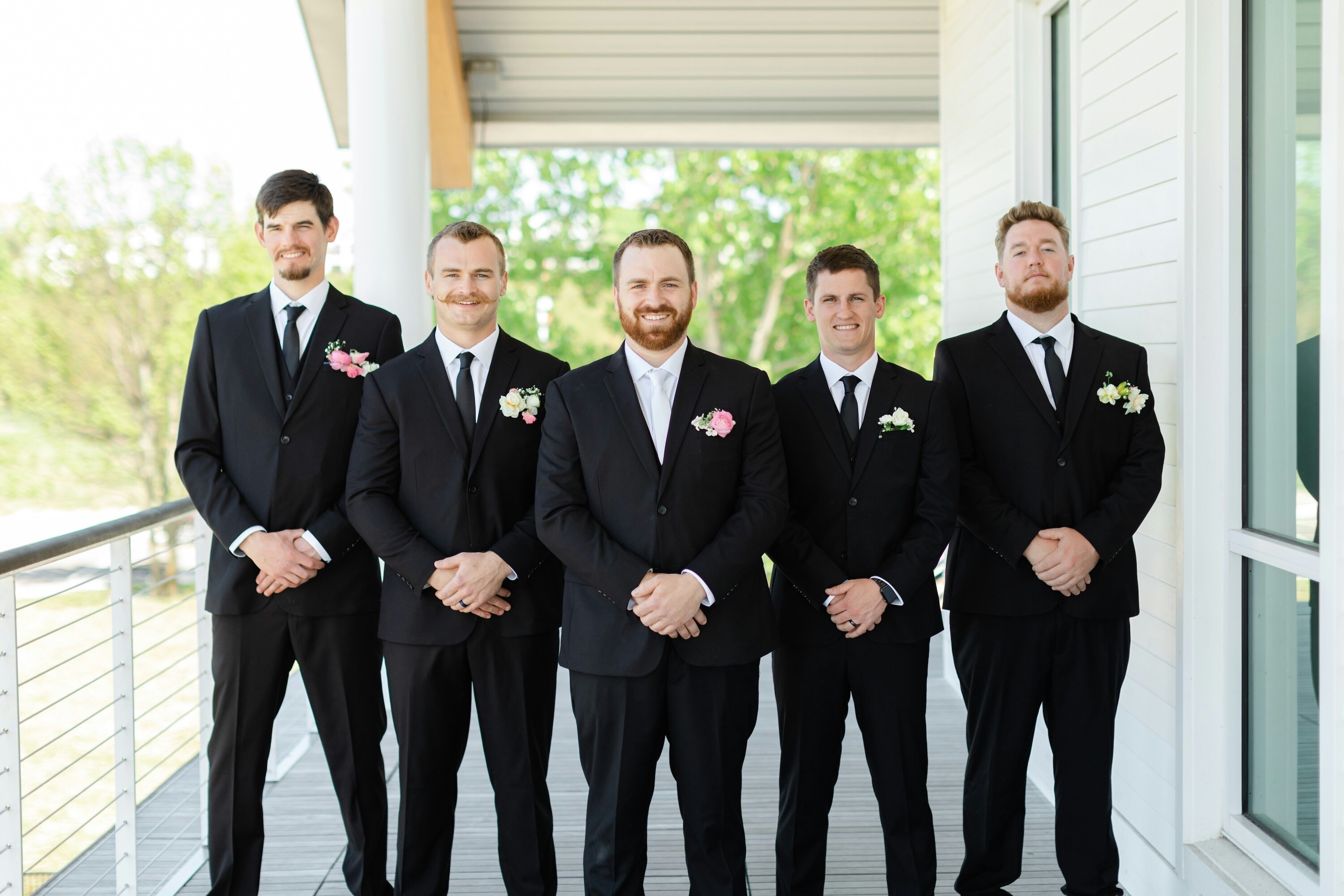 Groom standing with his groomsmen