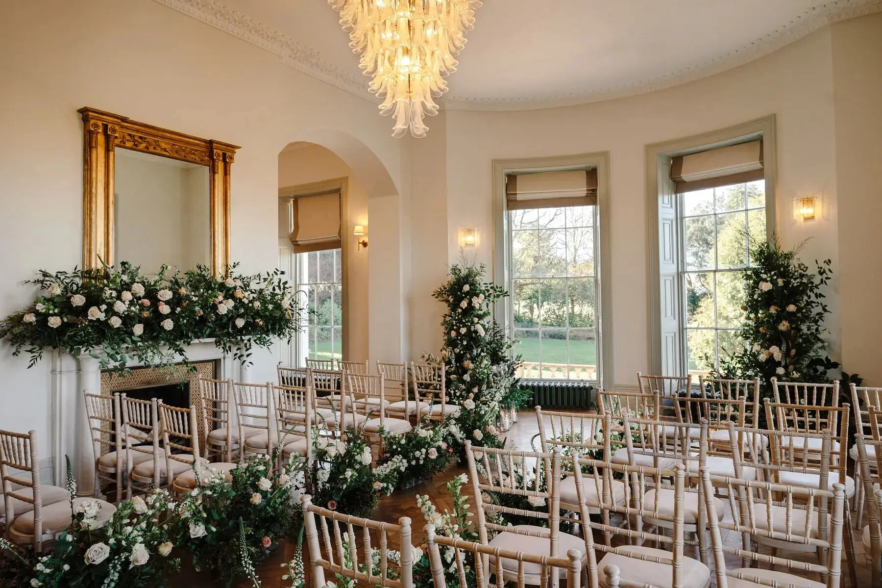 Wedding ceremony set up at Henlade House wedding venue, Somerset. With floral decor throughout the room.