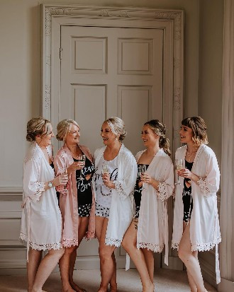 Bride getting ready with bridesmaids at Howsham Hall