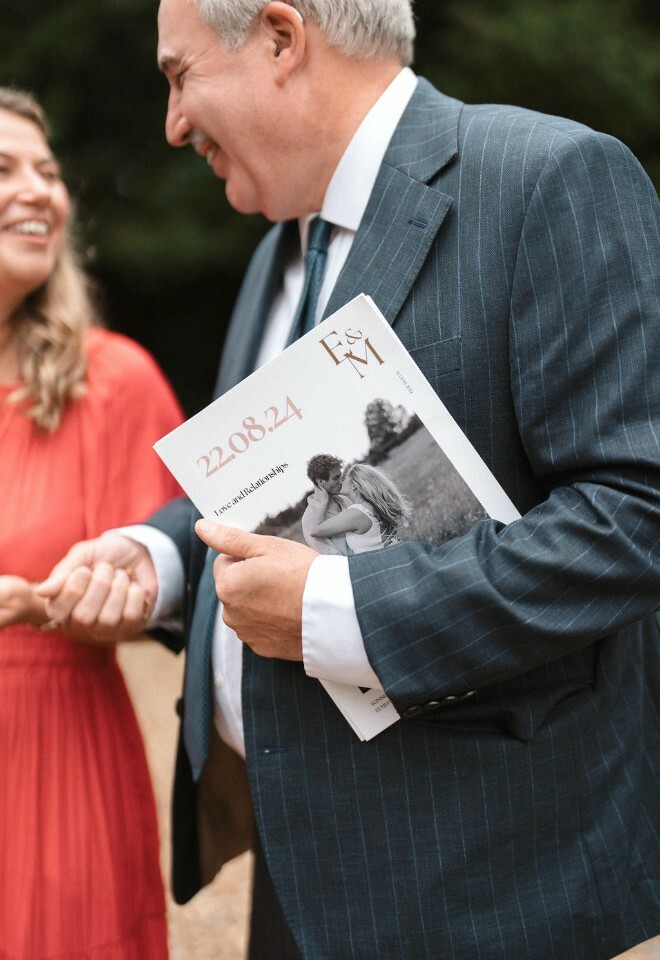 Wedding guest holds handmade magazine that bride created for the wedding ceremony order of service