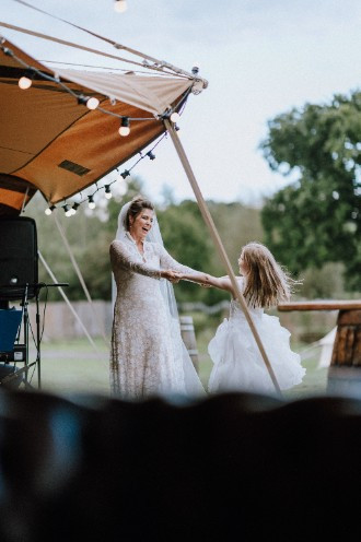 Bride dancing with child