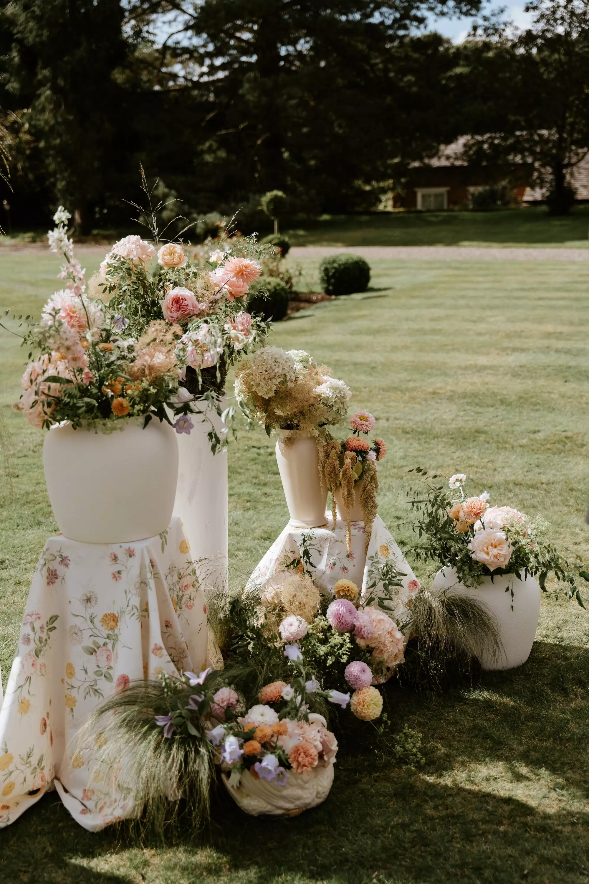 Pastel outdoor wedding ceremony arrangement featuring British flowers