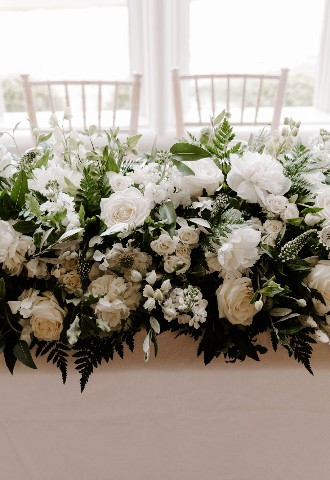Flowers on sweeheart table at Glewstone Court