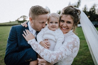 Bride and Groom with their baby