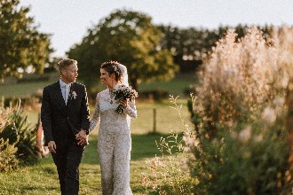 Bride and groom take a walk by the lake at Alcott Weddings