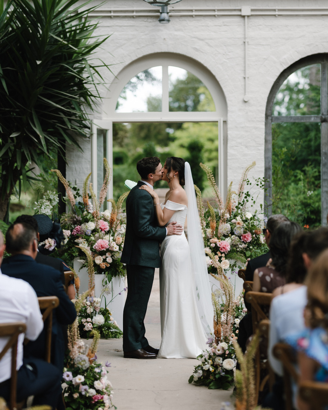 Bride and Groom sharing their first kiss as a married couple in The Glasshouse at Dukes Yard
