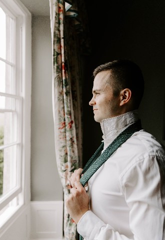 Groom getting ready at Glewstone Court