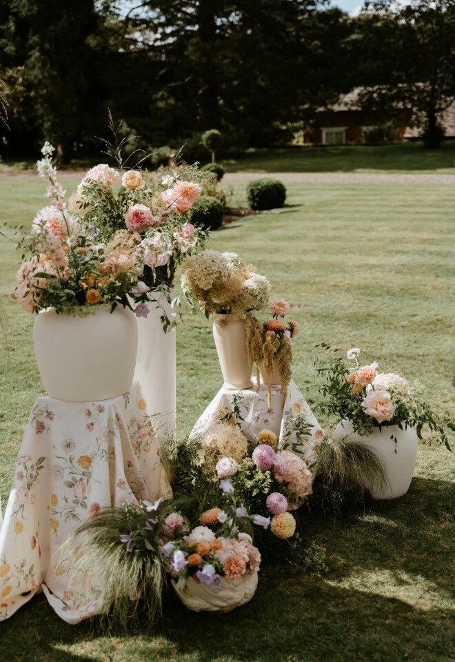Pastel wedding flower arrangement on the lawn at Davenport House in Shropshire