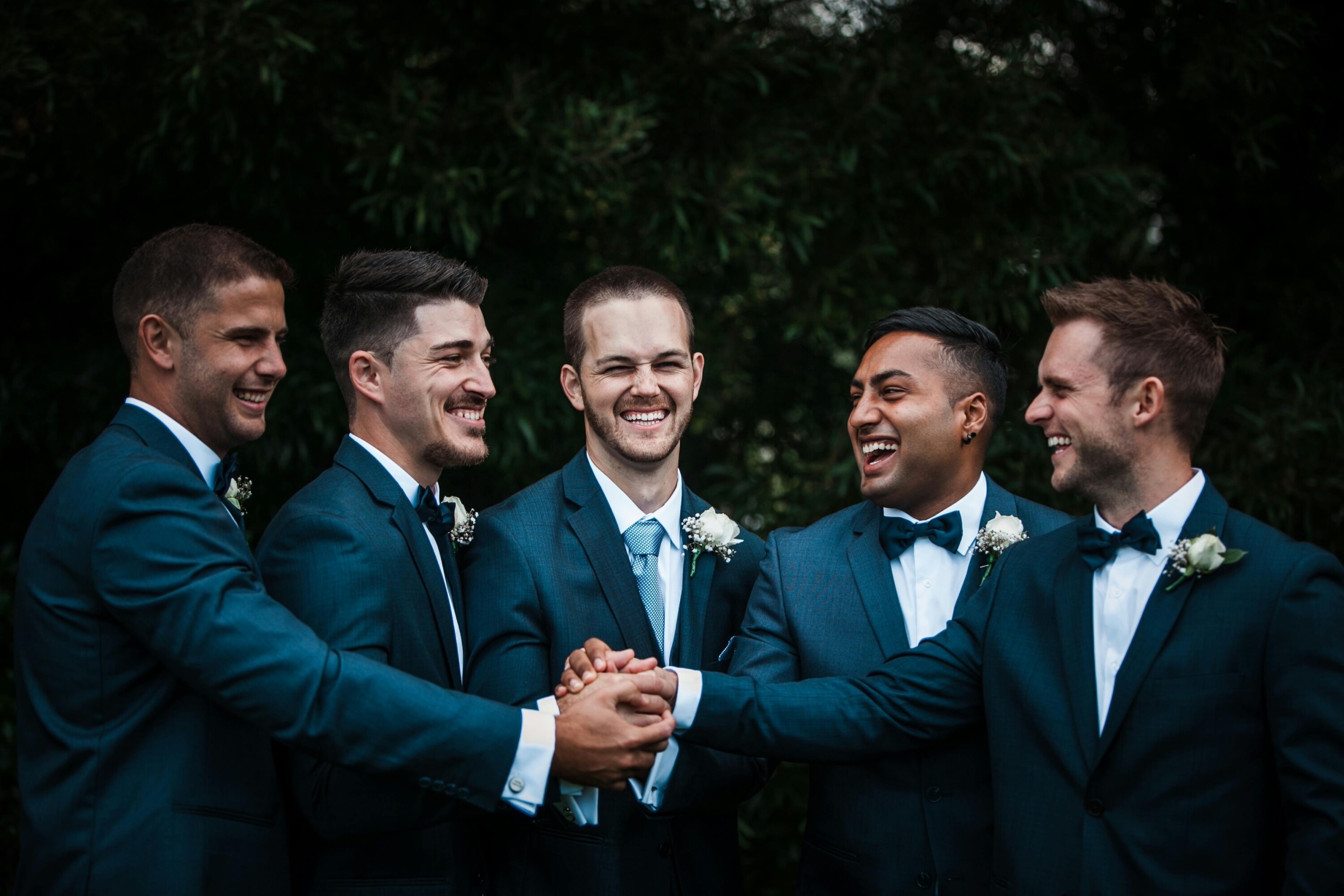 Groom and groomsmen smiling at each other