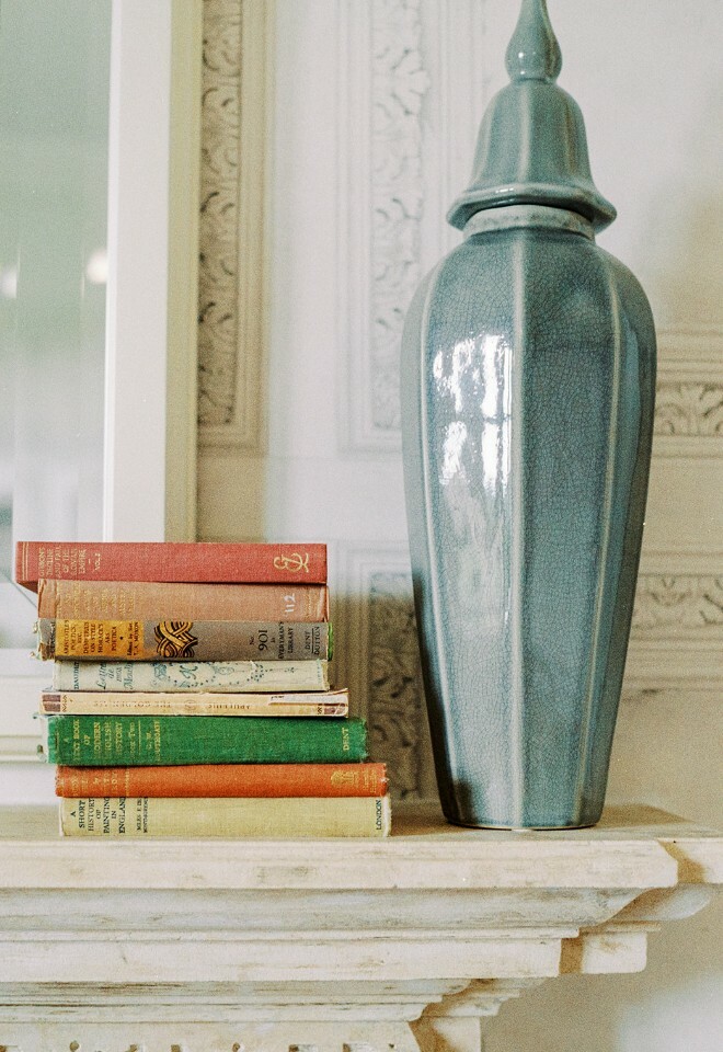 Books and lamp on a shelf at Clevedon Hall