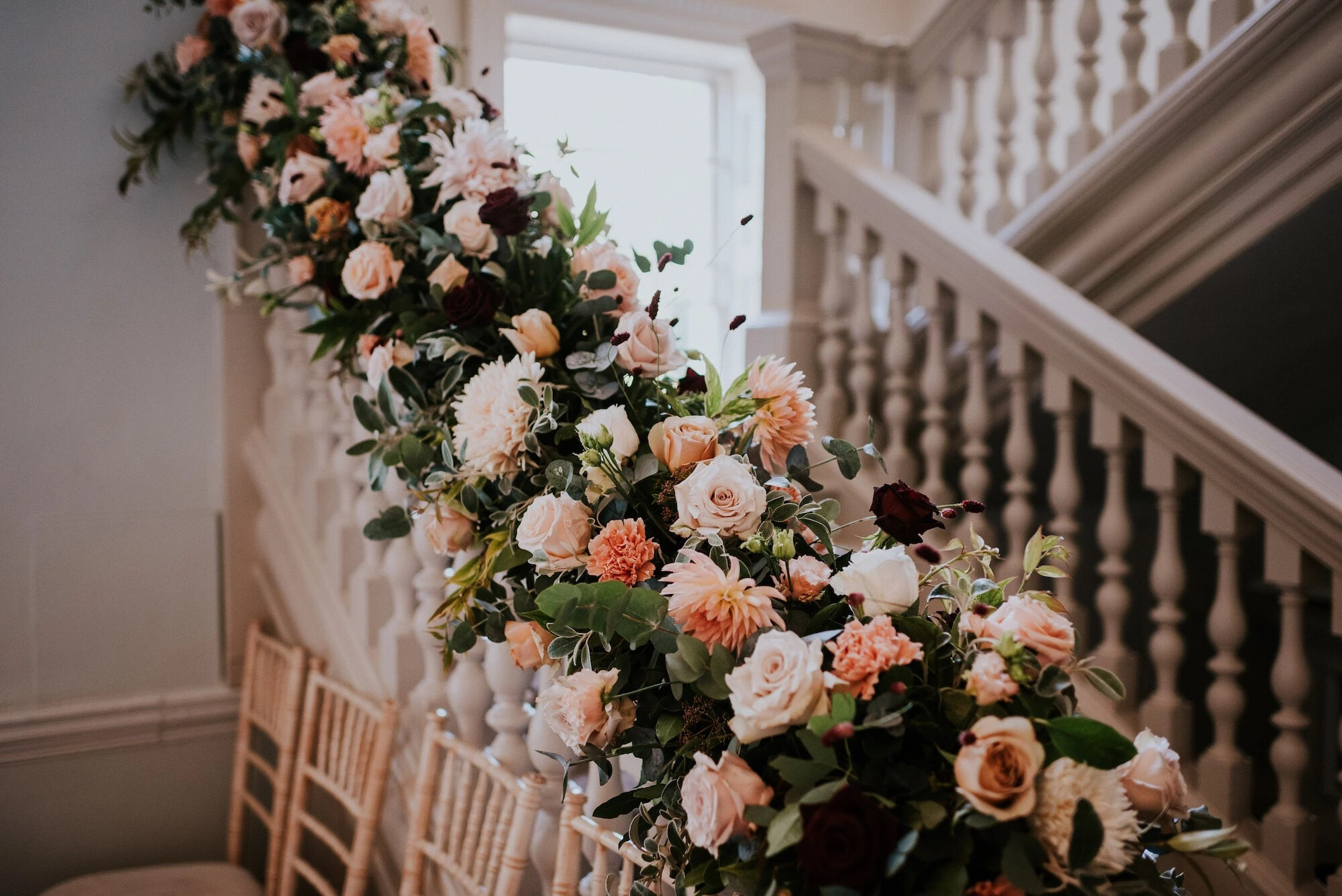 Autumnal floral arrangement running down stair bannister