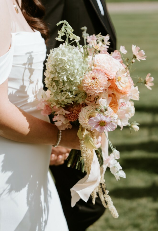 Close up image of the bride holding her pastel bouquet