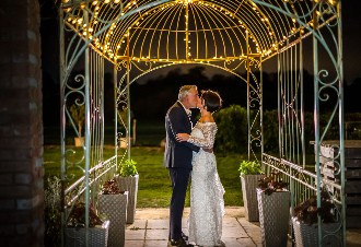 outside venue at night under fairylit canopy