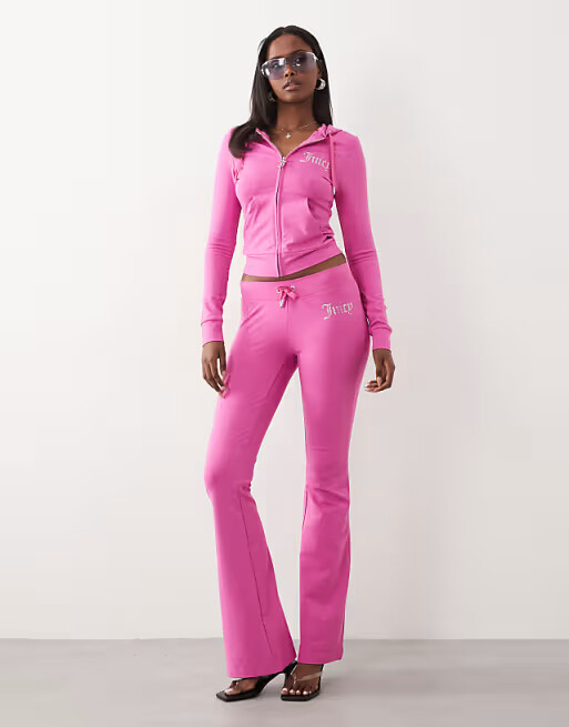 Model wearing a hot pink Juicy Couture zip-through hoodie with diamante logo detail, ideal for Barbie-themed hen party loungewear.