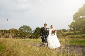 Bride and Groom Walking through grounds at St Mellion Estate