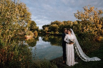 Bride and Groom on lake at Alcott weddings